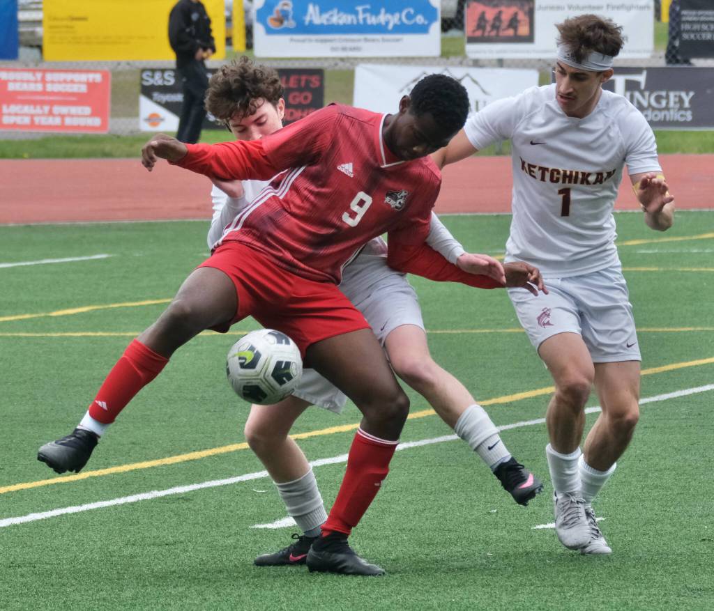 Juneau-Douglas High School: Yadaa.at Kalé junior Ahmir Parker (9) battles for a ball with Ketchikans Conner Pearson and Alex Gilley (1) during the Crimson Bears 2-0 region title clinching win over the Kings at Adair-Kennedy Field on Saturday. (Klas Stolpe / For the Juneau Empire)