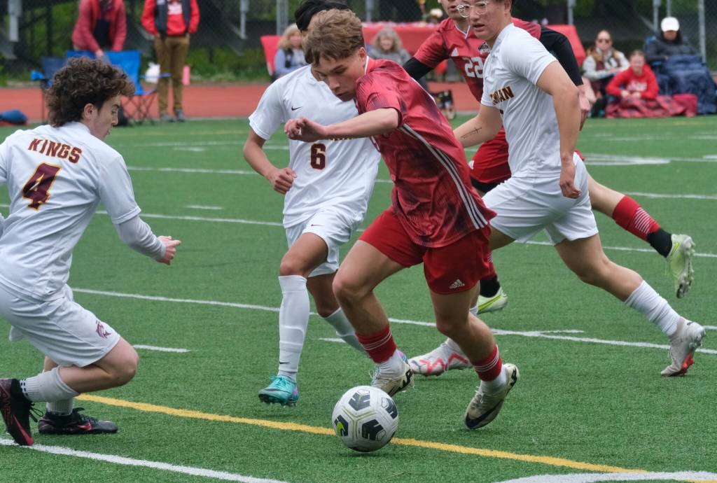 Juneau-Douglas High School: Yadaa.at Kalé junior Kai Ciambor moves the ball through Ketchikans Conner Pearson (4), RJ Cadiente (6) and Eunchong Lee during the Crimson Bears 2-0 region title clinching win over the Kings at Adair-Kennedy Field on Saturday. (Klas Stolpe / For the Juneau Empire)