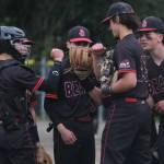 Juneau-Douglas High School: Yadaa.at Kalé senior battery Lamar Blatnick (catcher) and Landon Simonson (pitcher) bump fists on the mound with teammates as they begin their final home game at Adair-Kennedy Field on Saturday. (Klas Stolpe / For the Juneau Empire)