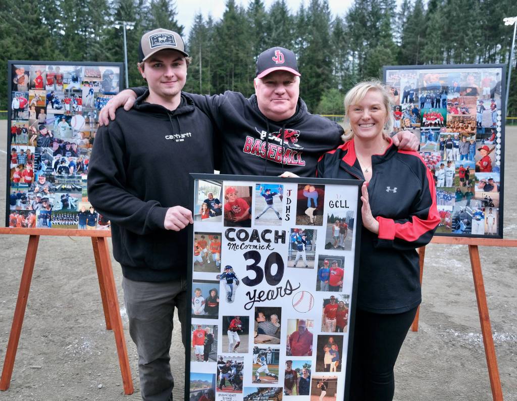 Erik McCormick, center, shown with son Brock and wife Melissa, was honored by the Juneau-Douglas High School: Yadaa.at Kalé baseball team on Saturday for his 30 years of community baseball service. (Klas Stolpe / For the Juneau Empire)