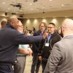 Democratic National Committee Chair Jaime Harrison greets the spouse of a party supporter via cell phone during the Alaska Democratic Partys state convention on Friday night at Elizabeth Peratrovich Hall. (Mark Sabbatini / Juneau Empire)