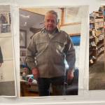 Jim Gerahgtys uncle Norm Israelson proudly models his new, pre-owned halibut jacket in a photo on his nephews wall posted with more than 50 other jacket buyers. (Laurie Craig / Juneau Empire)