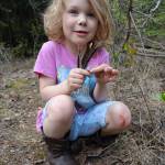 Rose Bulger, 6, holds grouse feathers she found during a family science expedition on the UAF campus. (Photo by Ned Rozell)