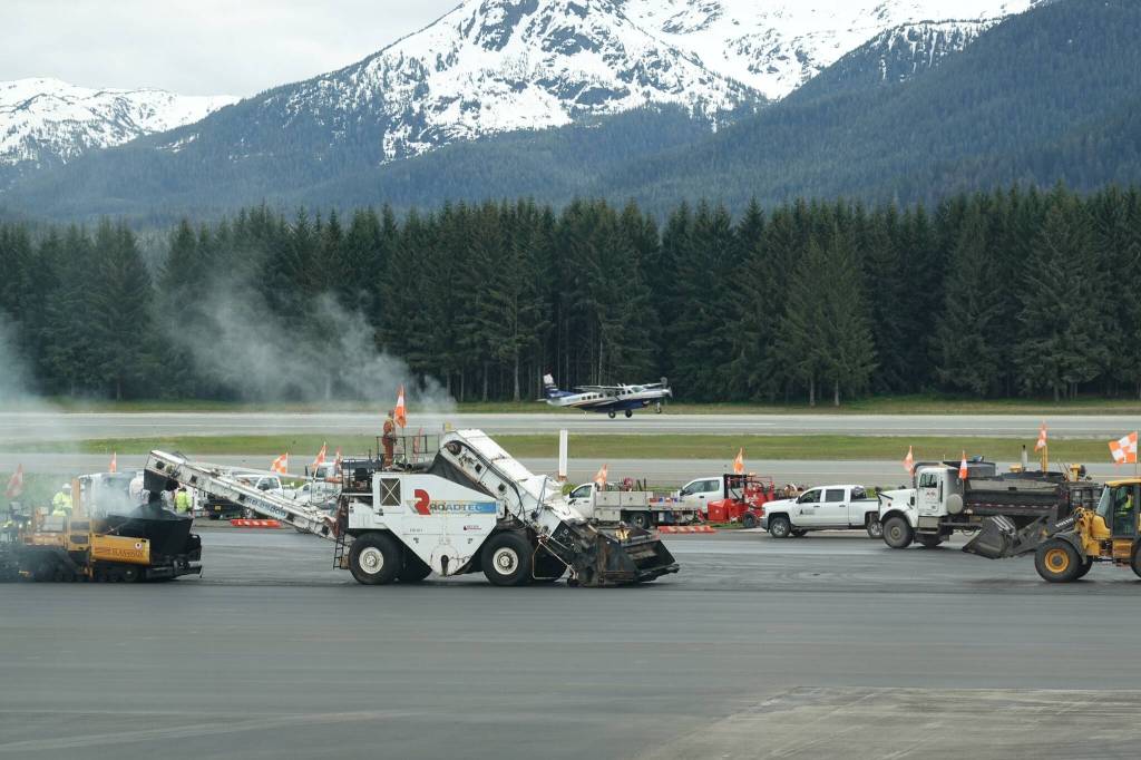 Dark asphalt is laid and compacted near an area where large aircraft can remain parked overnight at the airport. (Laurie Craig / Juneau Empire)