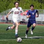 Juneau-Douglas High School: Yadaa.at Kalés Jesper Bennetsen and Soldotnas Andrew Arthur race for the ball during the ASAA Soccer Division II State Championships at Veterans Memorial Field in Wasilla on Saturday, May 25. (Jake Dye/Peninsula Clarion)