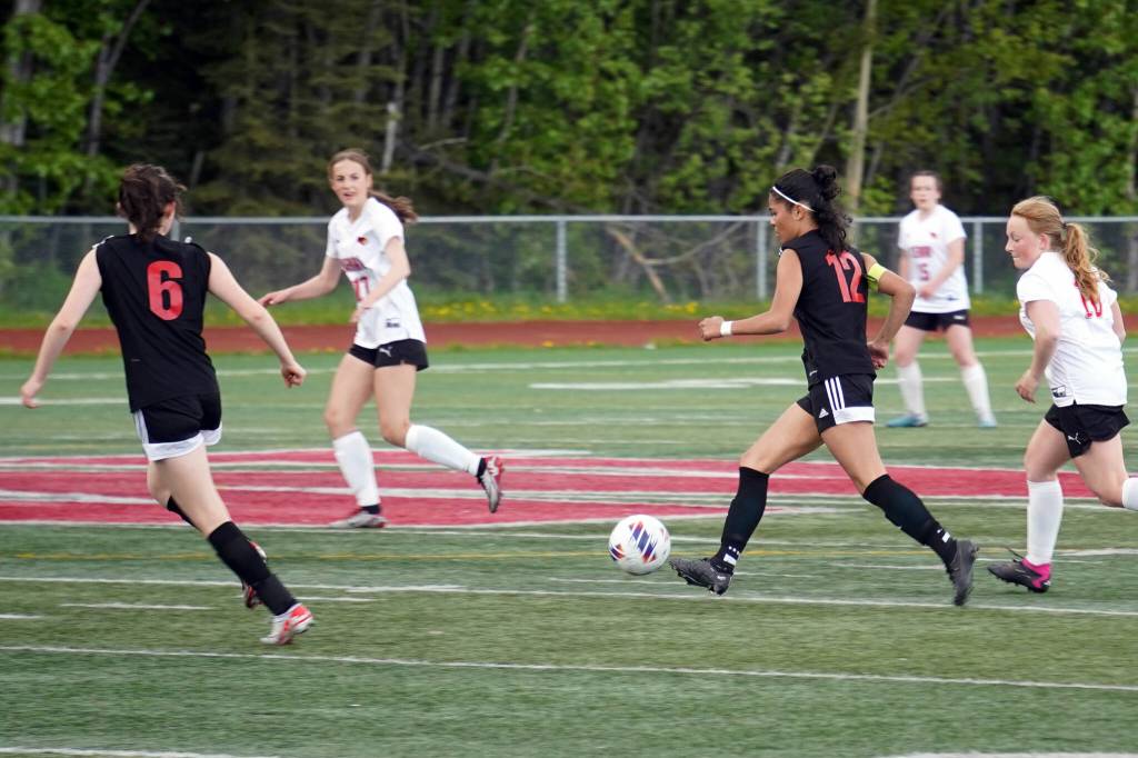 Juneau-Douglas High School: Yadaa.at Kalés Cadence Plummer moves with the ball during the ASAA Soccer Division II State Championships at Veterans Memorial Field in Wasilla on Saturday, May 25. (Jake Dye/Peninsula Clarion)