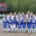 The Thunder Mountain High School softball team poses with their Region V championship award after defeating Sitka High School on Saturday night at Melvin Park. (Mark Sabbatini / Juneau Empire)