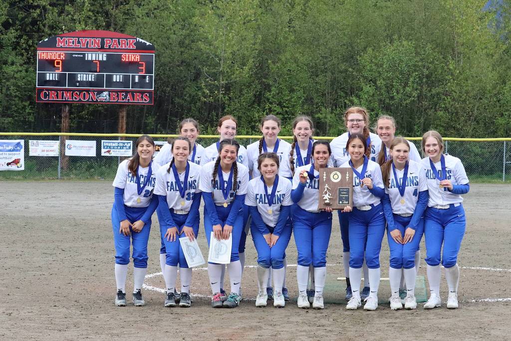 The Thunder Mountain High School softball team poses with their Region V championship award after defeating Sitka High School on Saturday night at Melvin Park. (Mark Sabbatini / Juneau Empire)