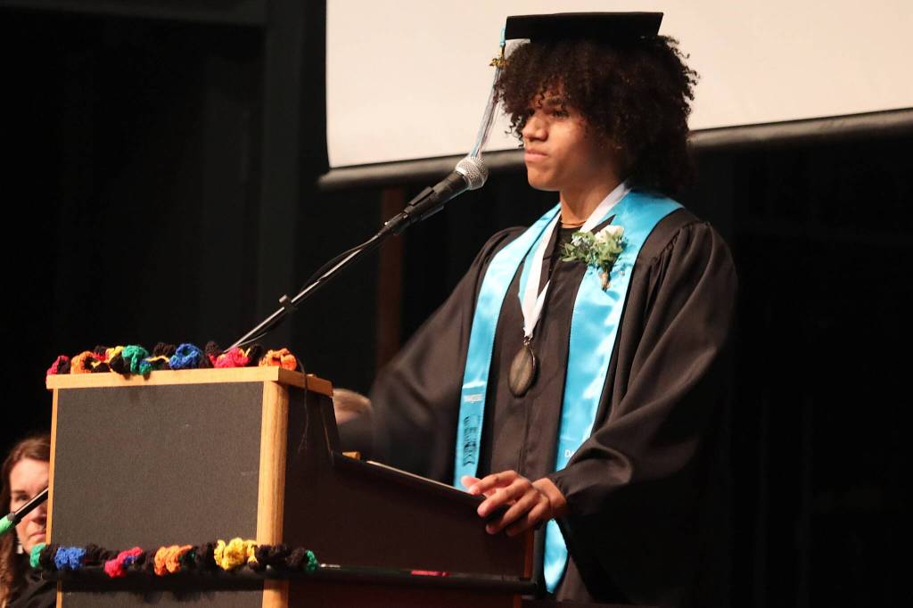 Kenyon Jordan delivers the student graduation speech during Yaaḵoosgé Daakahídi Alternative High Schools commencement ceremony in the Juneau-Douglas High School: Yadaa.at Kalé auditorium. (Mark Sabbatini / Juneau Empire)