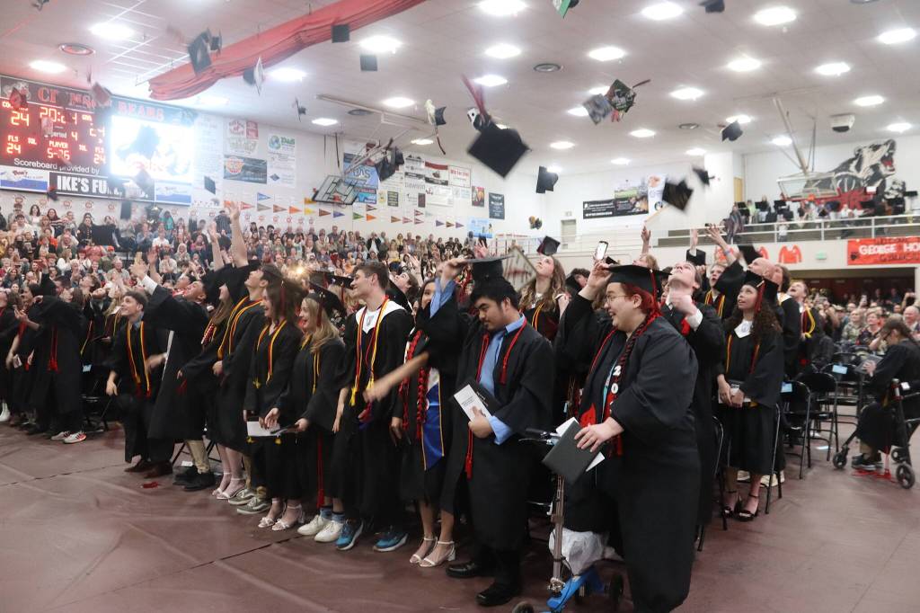 Students toss their graduation caps at the conclusion of Sundays commencement ceremony at Juneau-Douglas High School: Yadaa.at Kalé. (Mark Sabbatini / Juneau Empire)