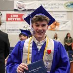 Thunder Mountain High School graduate Samuel Lockhart with his diploma. (Jasz Garrett / Juneau Empire)