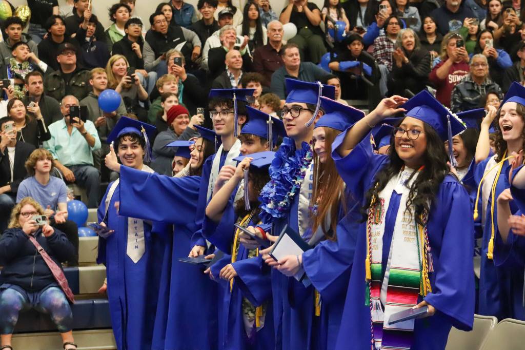 Thunder Mountain High School students move their tassels to the left after receiving their diplomas during Sundays commencement ceremony. (Jasz Garrett / Juneau Empire)