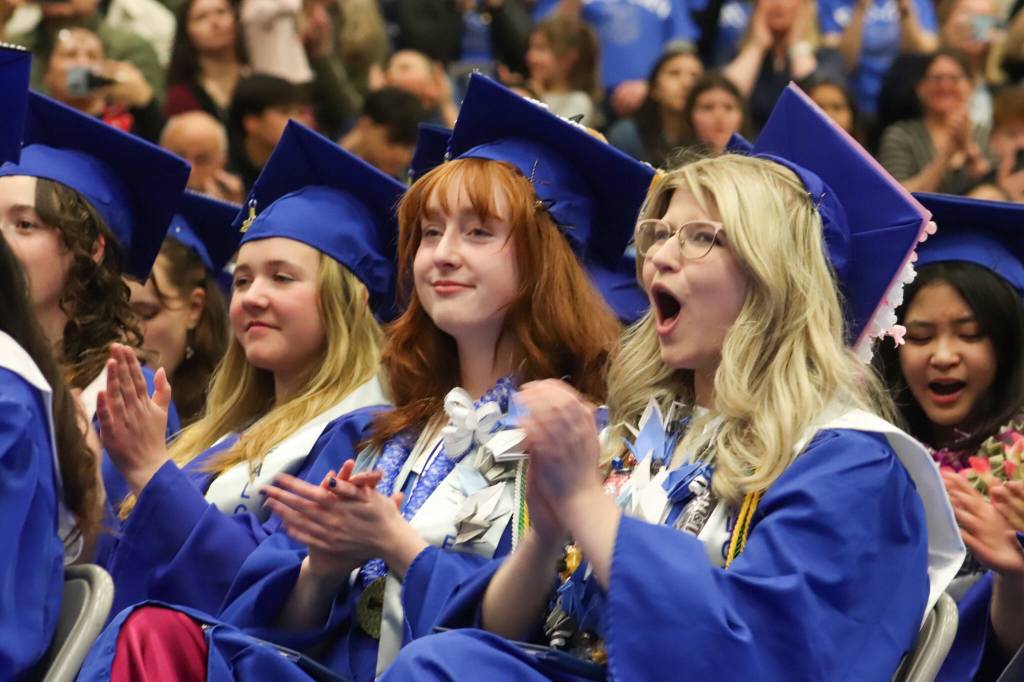 Thunder Mountain High School graduates clap for speakers during Sundays commencement ceremony. (Jasz Garrett / Juneau Empire)