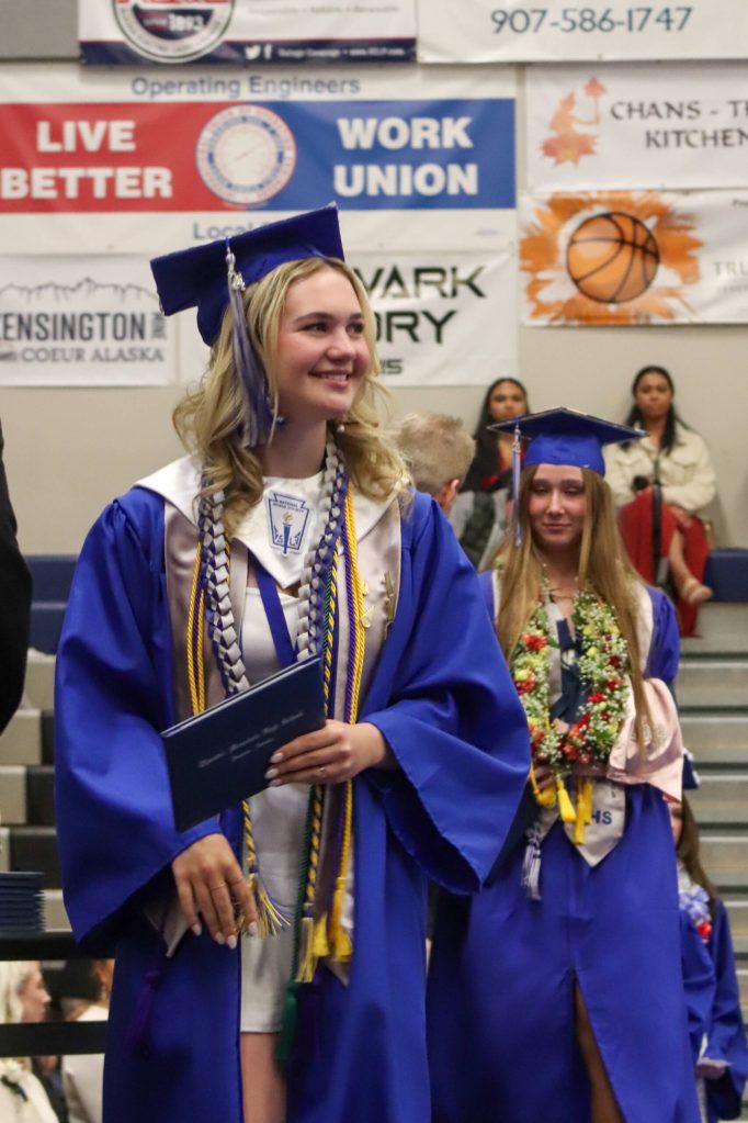 Thunder Mountain High School graduate Lacie Gehring with her diploma during Sundays commencement ceremony. (Jasz Garrett /Juneau Empire)