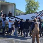 Wrangell community members worked together to get a 39-foot canoe provided by SEARHC out of its shipping container and into the water May 21. The 1,000-pound canoe traveled to Wrangell from Sitka by barge and will be used for the journey to Juneau for Celebration. (Photo courtesy of Valerie Massie)