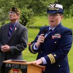 U.S. Coast Guard Cmdr. Brierley Ostrander delivers a Memorial Day speech to veterans, families and others during a ceremony Monday at Evergreen Cemetery. Listening at her left is Dan McCrummen, a Coast Guard veteran and quartermaster of the Veterans of Foreign Wars Taku Post 5559, who served as emcee of the ceremony. (Mark Sabbatini / Juneau Empire)