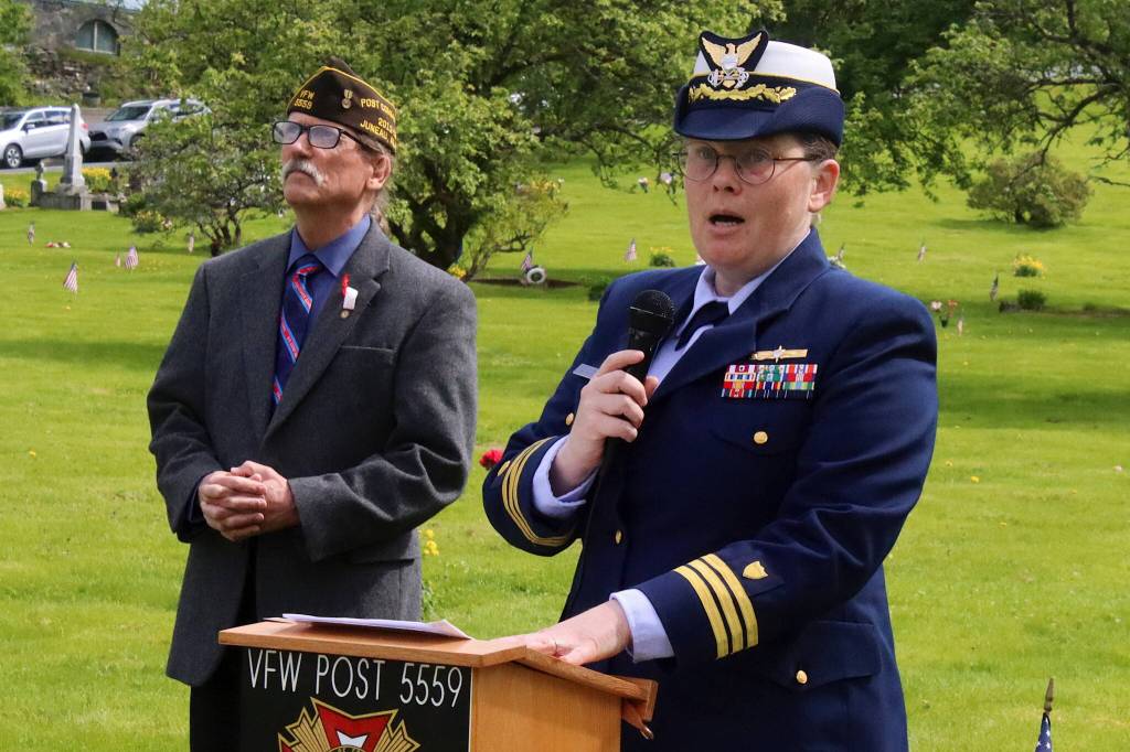 U.S. Coast Guard Cmdr. Brierley Ostrander delivers a Memorial Day speech to veterans, families and others during a ceremony Monday at Evergreen Cemetery. Listening at her left is Dan McCrummen, a Coast Guard veteran and quartermaster of the Veterans of Foreign Wars Taku Post 5559, who served as emcee of the ceremony. (Mark Sabbatini / Juneau Empire)
