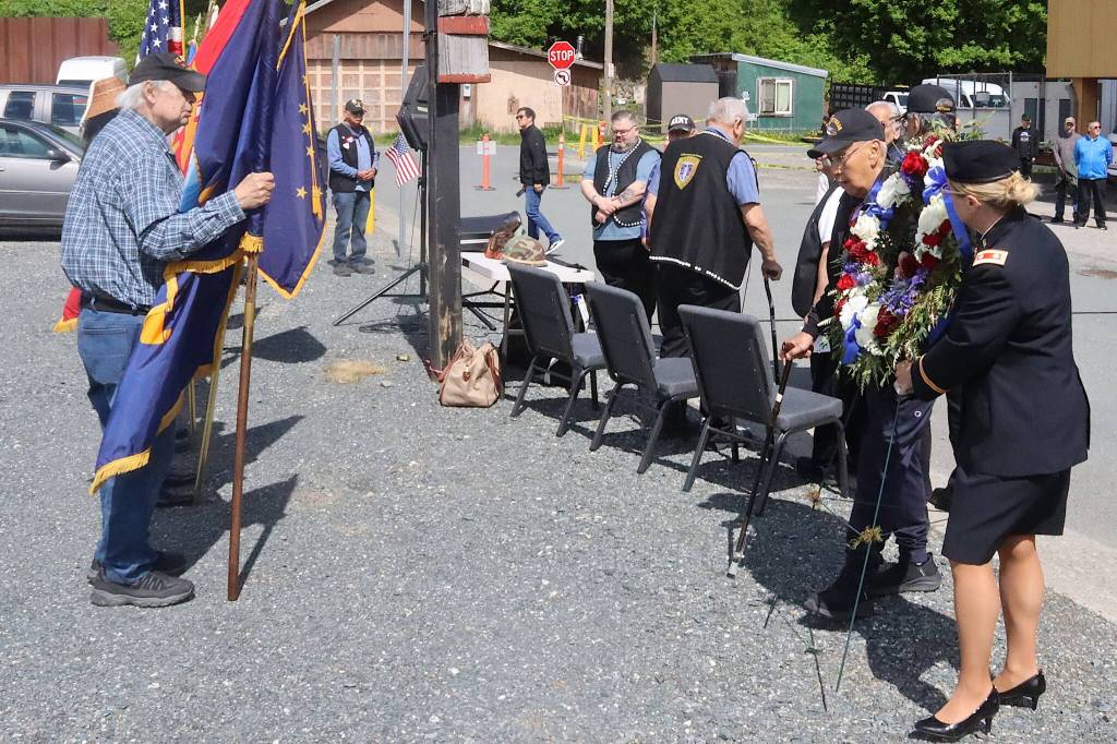 Ray Wilson (right), a Korea War veteran who served in the U.S. Army, helps place a wreath at the Southeast Alaska Native Veterans Memorial Park during a Memorial Day ceremony on Monday. (Mark Sabbatini / Juneau Empire)