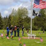 Wreath bearers present wreaths for fallen comrades, brothers and sisters in arms during a Memorial Day ceremony at Alaskan Memorial Park on Monday. Laying wreaths on the graves of fallen heroes is a way to honor and remember the sacrifices made. (Jasz Garrett / Juneau Empire)