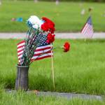 Flags decorating headstones were placed Thursday and will remain at the Alaskan Memorial Park until June 4. (Jasz Garrett / Juneau Empire)