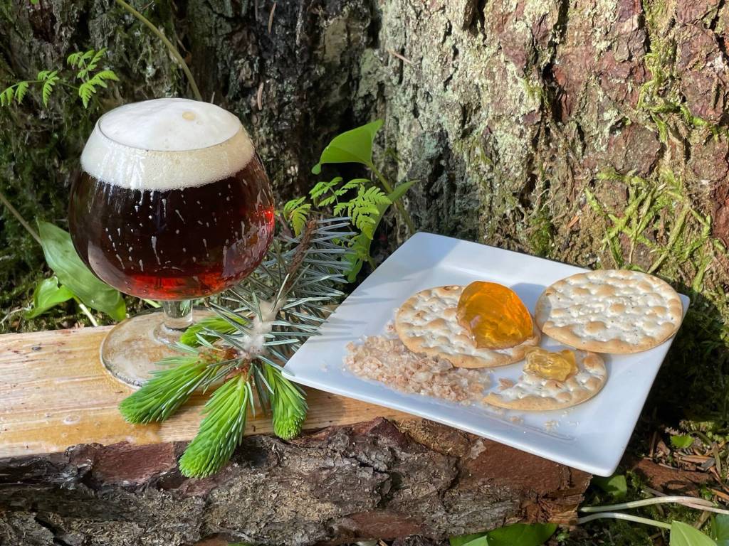 Some local culinary items made from spruce tips: salt flakes, jelly and beer. (Laurie Craig / Juneau Empire)