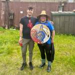 Corey Marsden and Kylee Guthrie pose with Guthries drum for a photo at their campsite in Juneau on Tuesday. (Jasz Garrett / Juneau Empire)