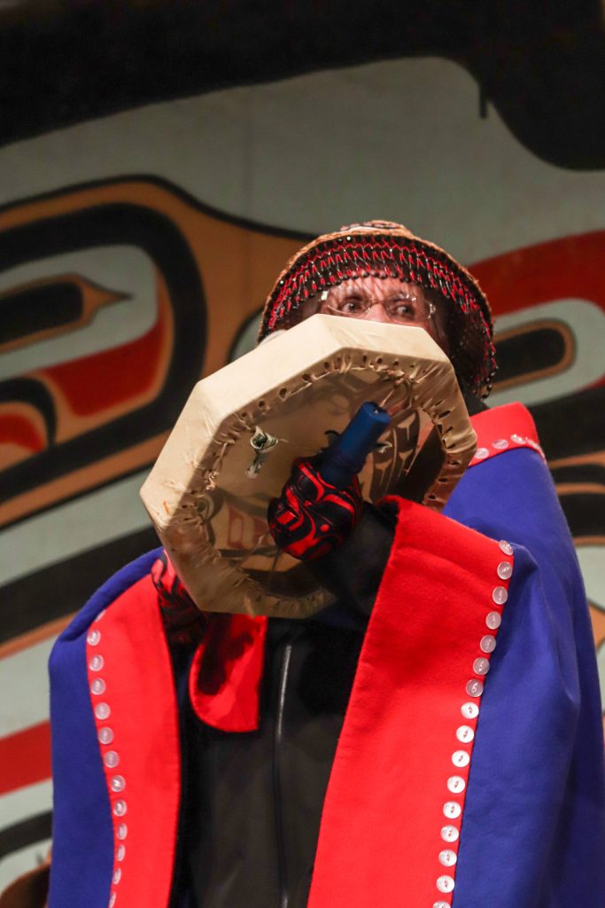 Fran Houston, spokesperson for the Áakw Kwáan, drums at Celebration. (Jasz Garrett / Juneau Empire)