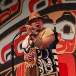 X̱unei Lance Twitchell, a professor of Alaska Native Languages at the University of Alaska Southeast, leads the Grand Entrance song. (Jasz Garrett / Juneau Empire)