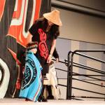 William Wallace, 3, of Saxman, stays close to his mother Markel during the toddler regalia review as part of Celebration on Thursday at Centennial Hall. (Mark Sabbatini / Juneau Empire)