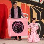 Elizabeth Peele, 3, a Saxton resident, is accompanied by her father Charles during the toddler regalia review as part of Celebration on Thursday at Centennial Hall. (Mark Sabbatini / Juneau Empire)