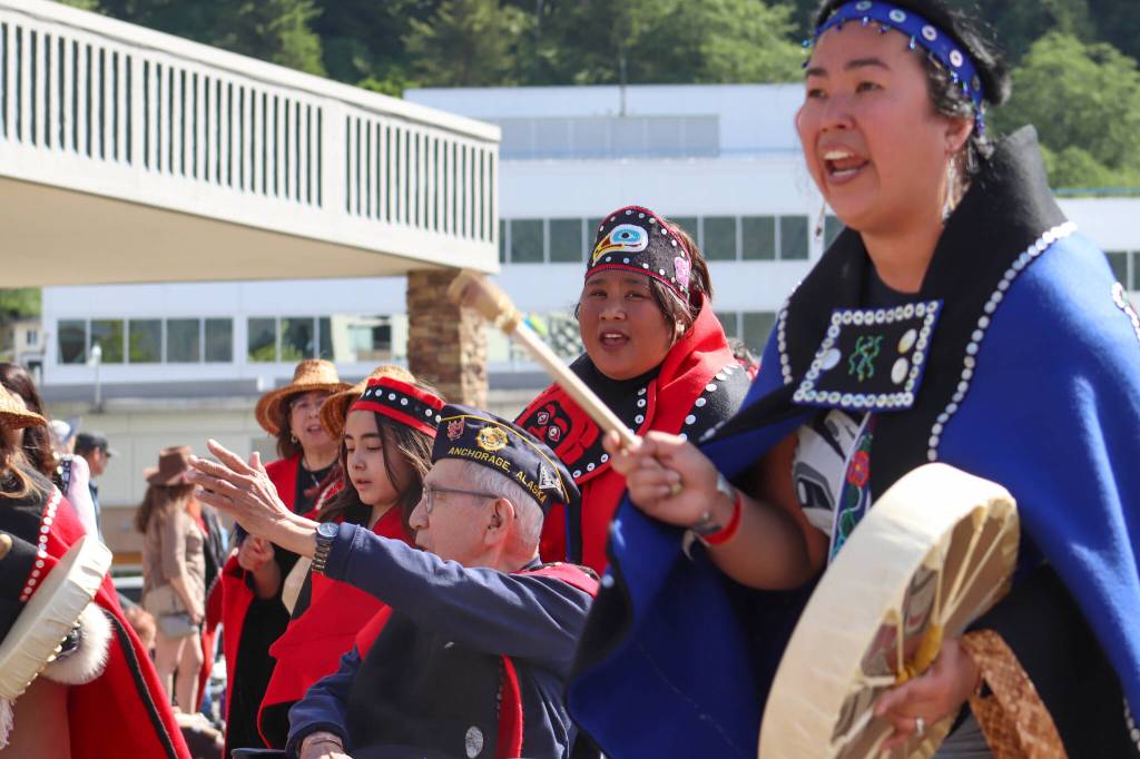 The Áanchichx Kwaan People of Anchorage Dance Group parades through downtown Juneau. (Jasz Garrett / Juneau Empire)