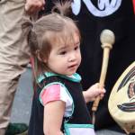 Srivani Brown from Yakutat, 2, drums during the Grand Exit for Celebration. (Jasz Garrett / Juneau Empire)