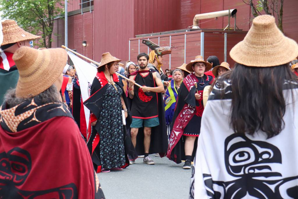 The Tsmaay dance group waiting their turn outside Centennial Hall for the Grand Exit ceremony on Saturday evening. (Jasz Garrett / Juneau Empire)