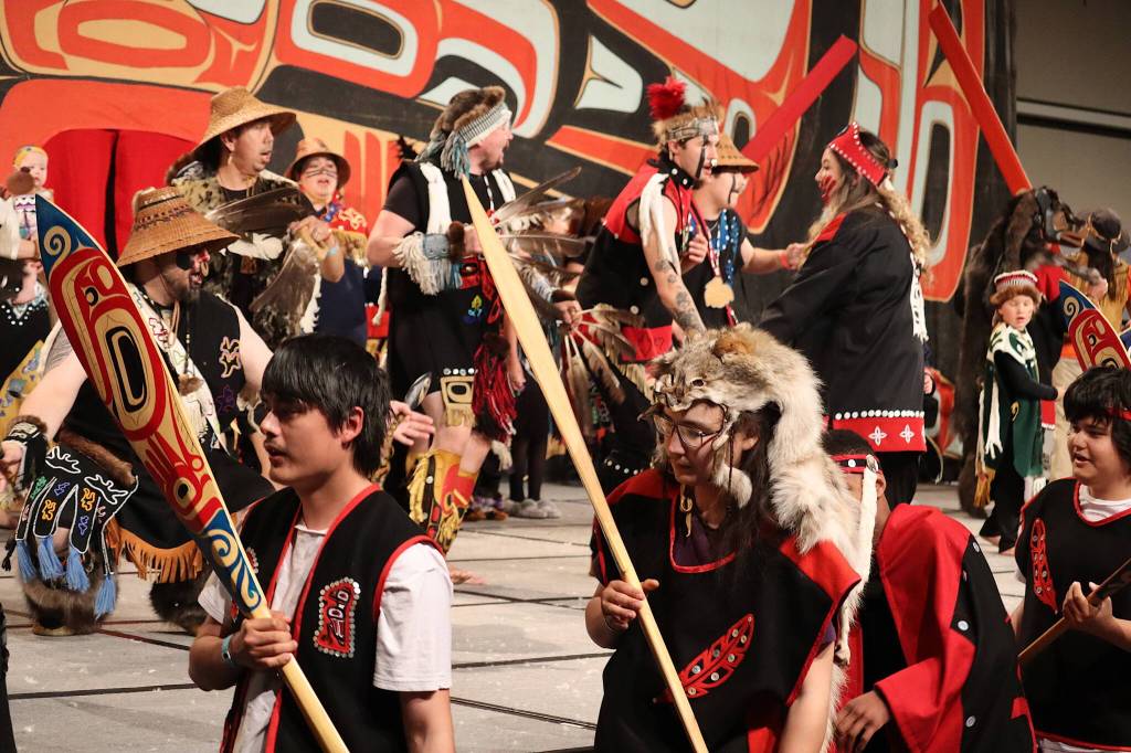 Cerebration participants cross in front of the main stage during their Grand Exit on Saturday evening at Centennial Hall. (Mark Sabbatini / Juneau Empire)