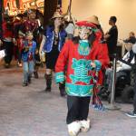 Luella Tumlak, an Anchorage resident, wears clothing made by her grandmother and regalia from her father as she exists the main ballroom at Centennial Hall during Celebrations Grand Exit ceremony on Saturday night. (Mark Sabbatini / Juneau Empire)