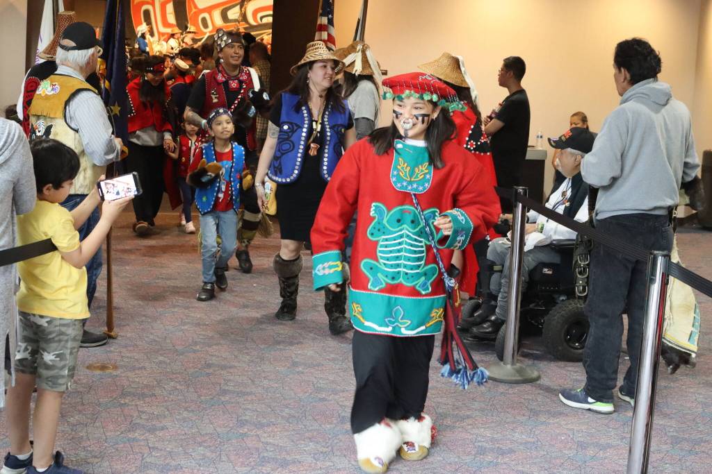 Luella Tumlak, an Anchorage resident, wears clothing made by her grandmother and regalia from her father as she exists the main ballroom at Centennial Hall during Celebrations Grand Exit ceremony on Saturday night. (Mark Sabbatini / Juneau Empire)