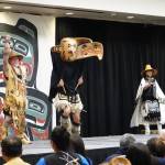 Illustrating a story of an eagle who fed a starving village as a returned kindness, a dancer opens a large carved eagle headdress to reveal the inner being during a performance by Git Hoan dancers Saturday at Elizabeth Peratrovich Hall. (Laurie Craig / Juneau Empire)