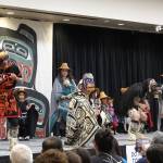 Four dancers manipulate their carved masks to open and shut the eyelids on the painted wooden masks carved by David A. Boxley of Git Hoan as dancers sing and drum on Saturday at Elizabeth Peratrovich Hall. (Laurie Craig / Juneau Empire)