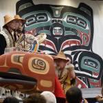 David A. Boxley, wearing a Ravenstail-trimmed robe, and his son David R. Boxley sing and drum in Elizabeth Peratrovich Hall on Saturday afternoon as Metlakatlas Git Hoan dancers perform a canoe paddling dance featuring a large carved headdress created by Git Hoans senior Boxley. (Laurie Craig / Juneau Empire)