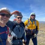 Bruno Grunau, Ned Rozell and Forest Wagner hike a ridgetop near Mastodon Dome in the AlaskAcross 2024, a 50-mile race. (Photo by Bruno Grunau)