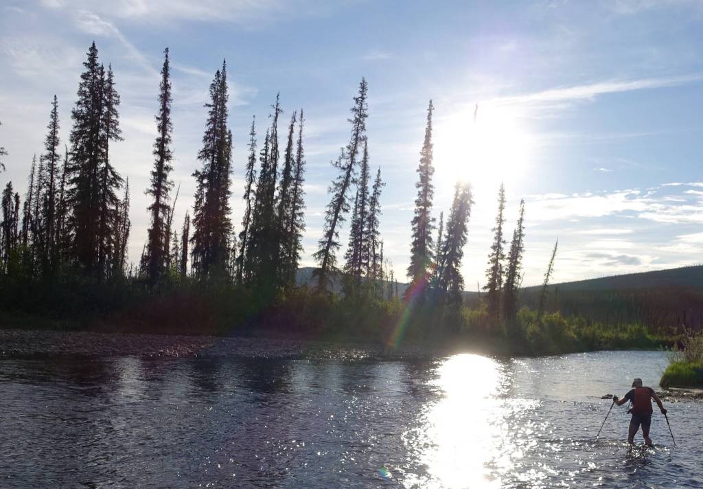 Bruno Grunau crosses the Ikheenjik River (formerly known as Birch Creek), the major water obstacle during the AlaskAcross 2024 race from Eagle Summit to Chena Hot Springs resort. (Photo by Ned Rozell)