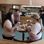 Daryl Cryts and Megan Seitz, both lifelong Juneau residents, try the donuts and drinks at Jellyfish Donuts and Dumplings on Sunday. (Mark Sabbatini / Juneau Empire)