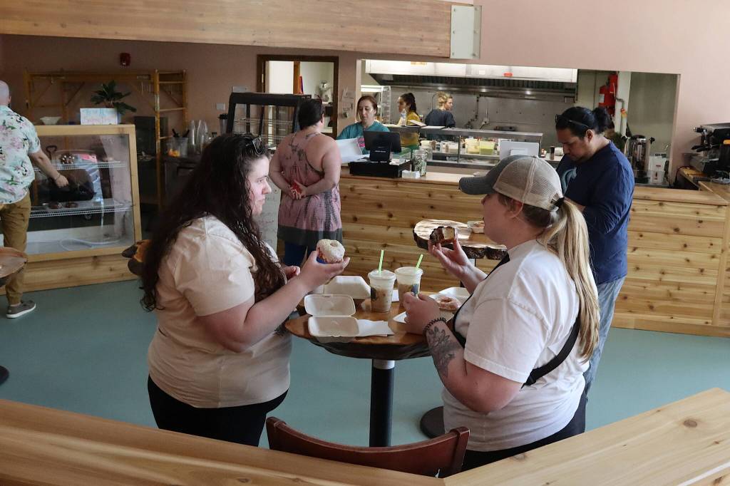 Daryl Cryts and Megan Seitz, both lifelong Juneau residents, try the donuts and drinks at Jellyfish Donuts and Dumplings on Sunday. (Mark Sabbatini / Juneau Empire)