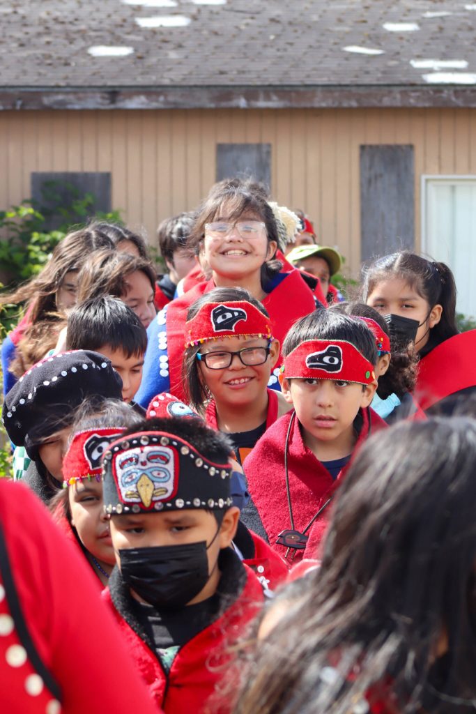 The Angoon Youth Dance Group files into the Angoon Elementary School gymnasium. (Jasz Garrett / Juneau Empire)