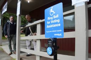 Observers from the U.S. Department of Justice examine the accessibility of a polling place in Juneaus Mendenhall Valley during the Aug. 16, 2022, primary election. The Justice Department concluded that the state violated the Americans with Disabilities Act by failing to properly accommodate voters with disabilities. (James Brooks/Alaska Beacon)