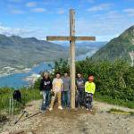 Workers stand next to the Father Browns Cross after they reinstalled it at an overlook site on Mount Roberts on Wednesday. (Photo courtesy of Hugo Miramontes)
