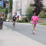Jason Norat, wearing his girlfriends pink tutu, nears the finish line as the winner of the 5K race during the Only Fools Run At Night on Friday. (Mark Sabbatini / Juneau Empire)