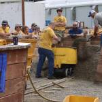 Eddie Petrie shovels gravel into a mine cart as fast as possible during the mens hand mucking competition as part of Juneau Gold Rush Days on Saturday at Savikko Park. (Mark Sabbatini / Juneau Empire)