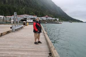Tim Berry, a Michigan resident visiting Juneau, fishes on a dock Monday near the Douglas Island Pink and Chum Inc.s Macaulay Salmon Hatchery. A ban catching king salmon near the hatchery and some other Juneau waters is in effect until Aug. 31. (Mark Sabbatini / Juneau Empire)