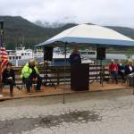 City and state leaders gather Monday at the gangway to Aurora Harbor for a ribbon-cutting ceremony to celebrate the completion of the third of four stages of reconstruction of the 60-year-old harbor. (Mark Sabbatini / Juneau Empire)